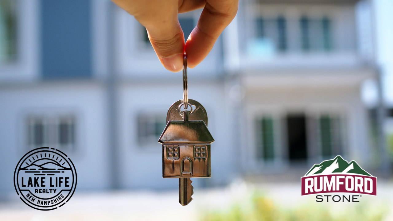 A person holding a house shaped key, with the Lake Life realty Logo and Rumford Stone logo.